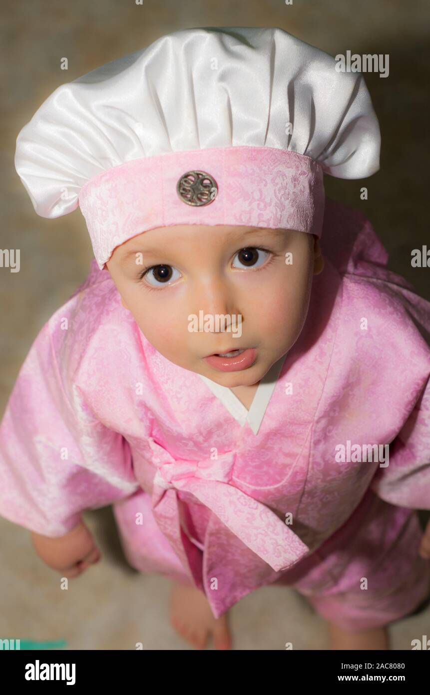 A child standing in a pink Japanese-style dress Stock Photo