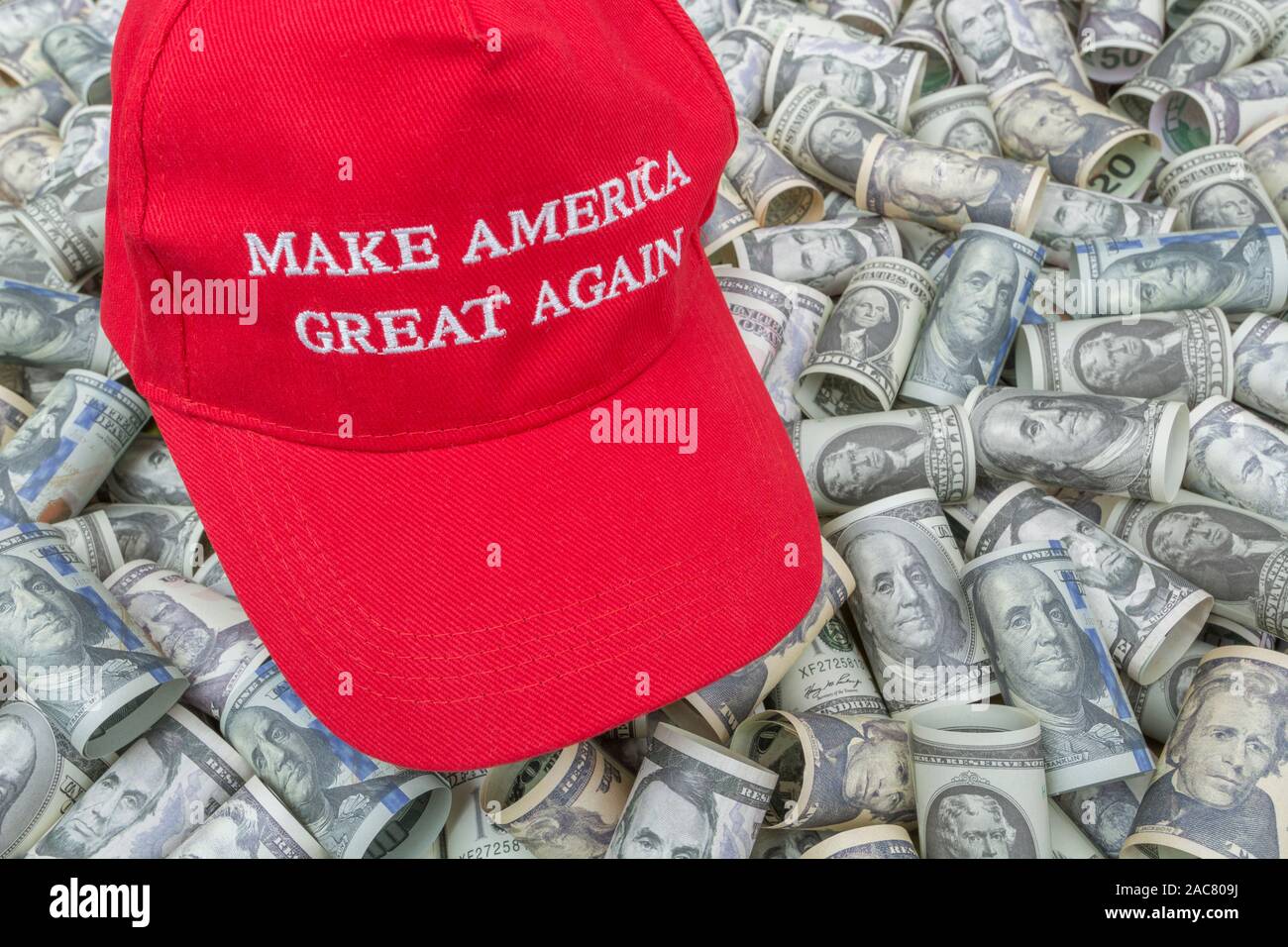 Red Trump MAGA / Make America Great Again cap hat + dollar bills (See  NOTES). For booming US economy / Trump Economy, US elections, Trump tax  cuts Stock Photo - Alamy