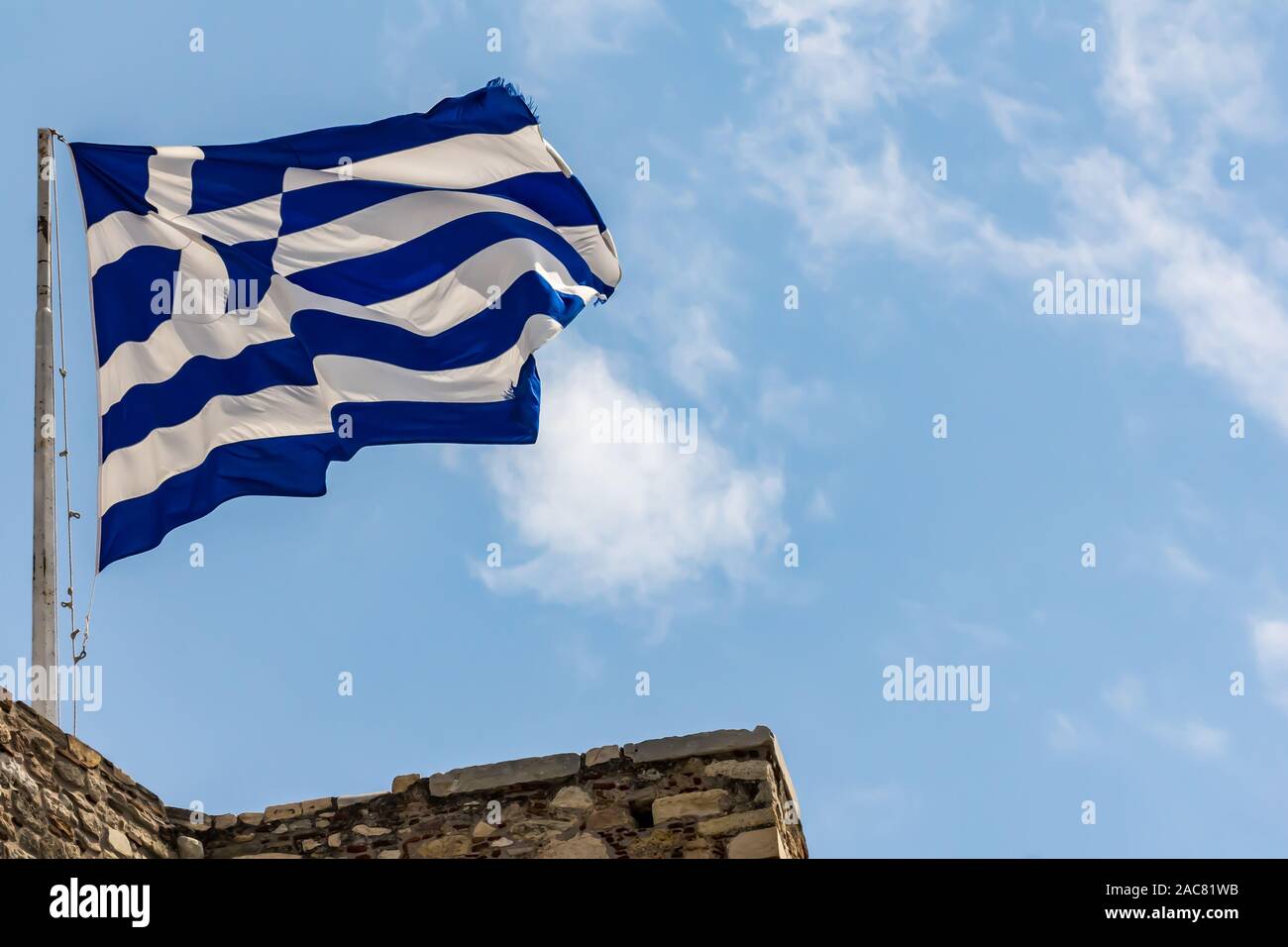 Greek national flag waving on blue sky background. Hellenic Republic, GR Stock Photo