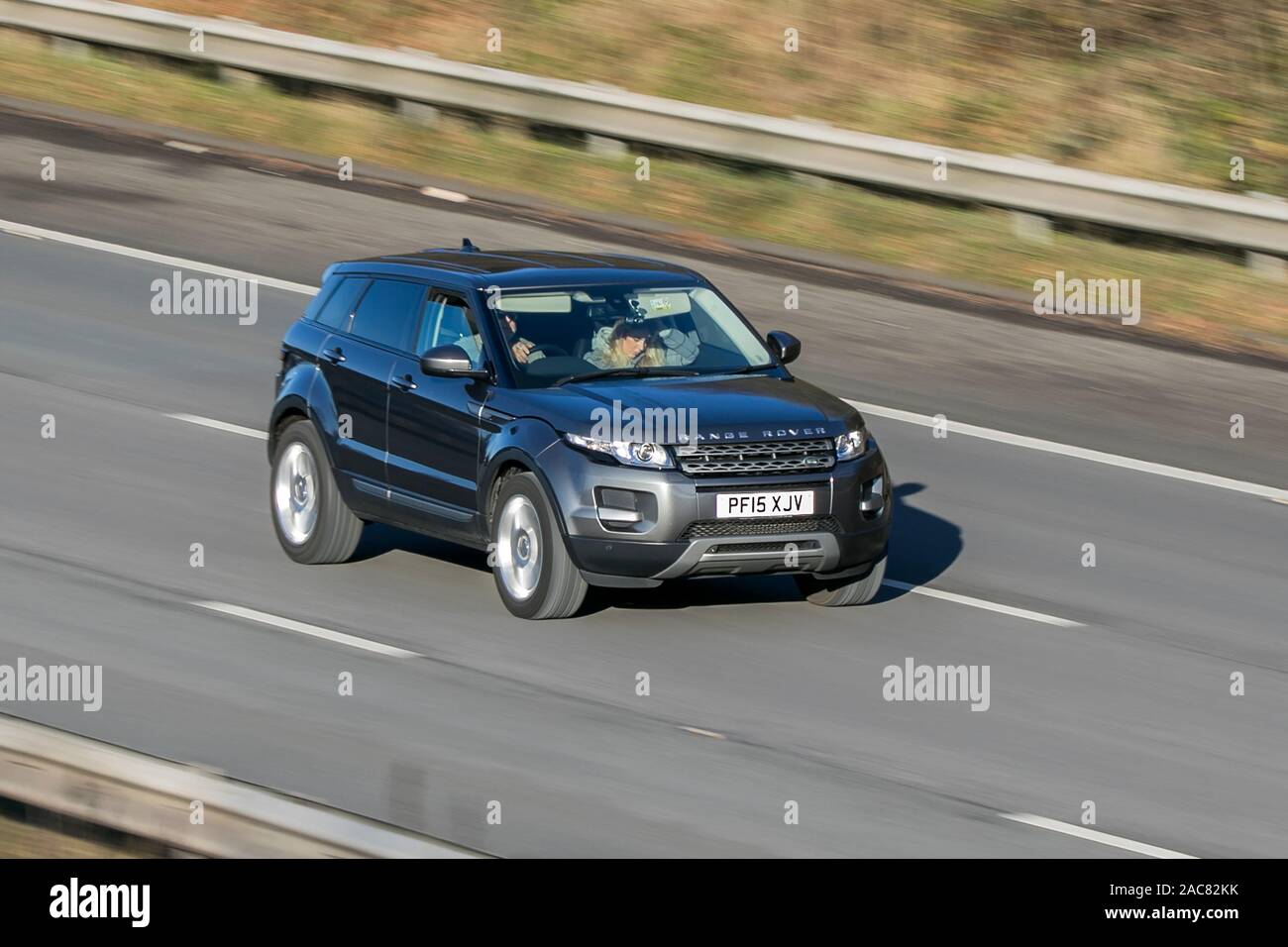 Blurred moving car 2015 Land Rover Range Rover Evoque Pure traveling at speed on the M61 motorway Slow camera shutter speed vehicle movement Stock Photo