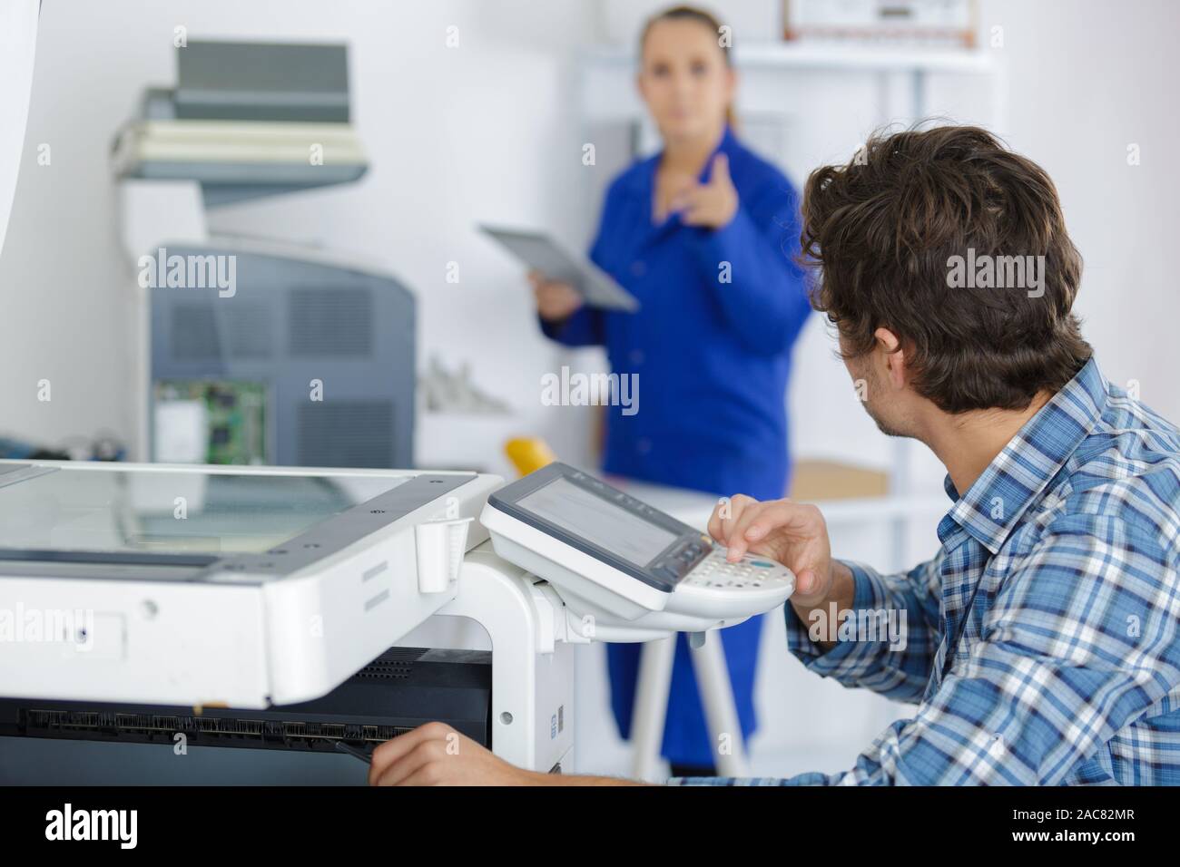 a technician fixing a printer Stock Photo