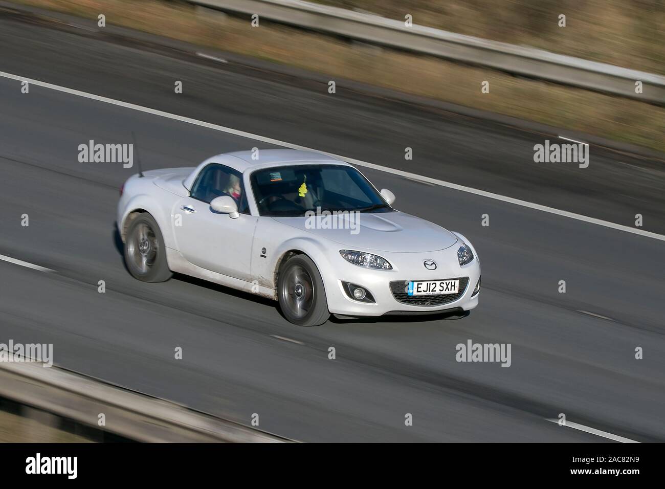 Mazda Mx-5 I Roadster Venture E; Blurred moving car traveling at speed on the M61 motorway; Slow camera shutter speed vehicle movement, Manchester, UK Stock Photo