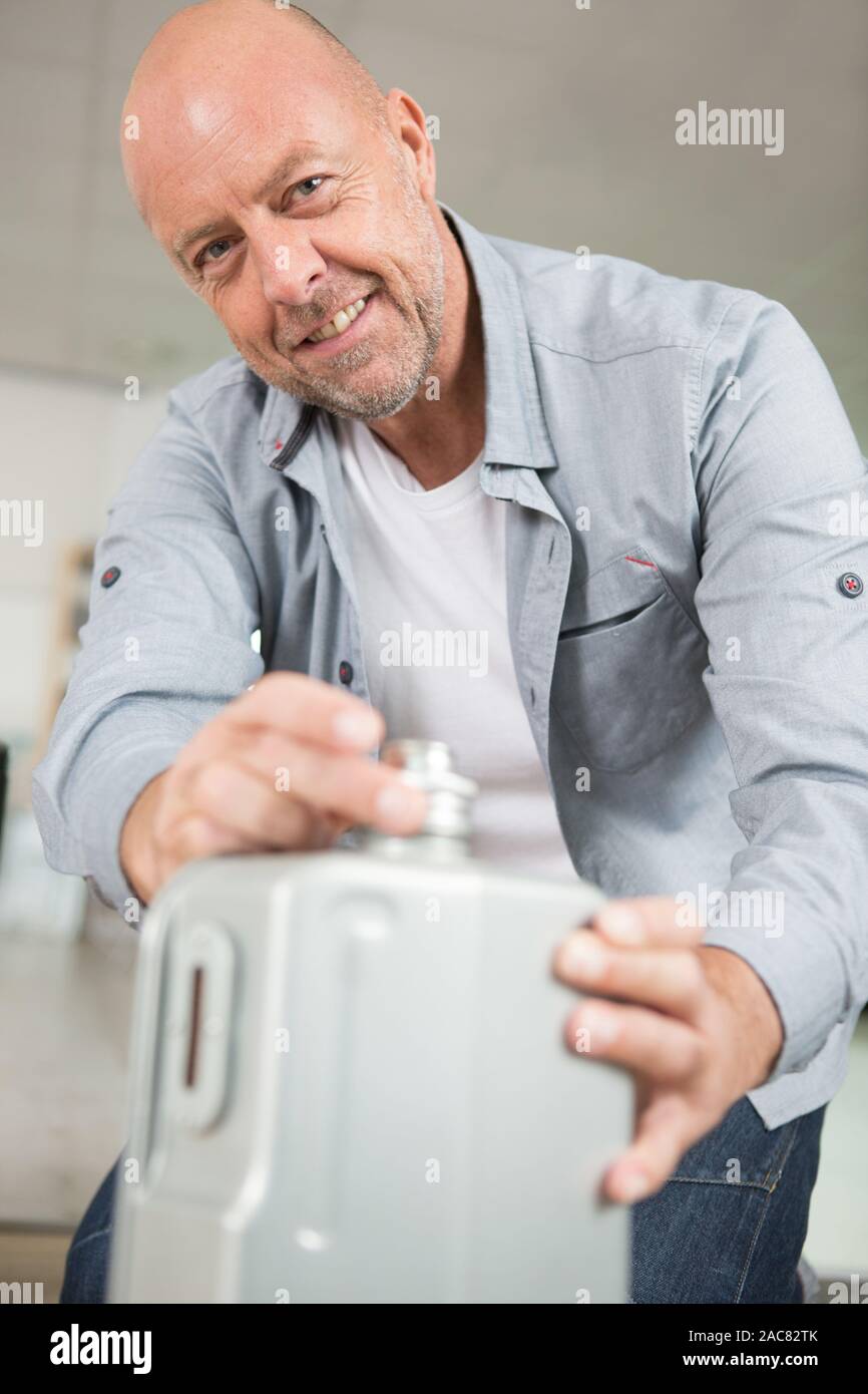 a man closing oil canister Stock Photo