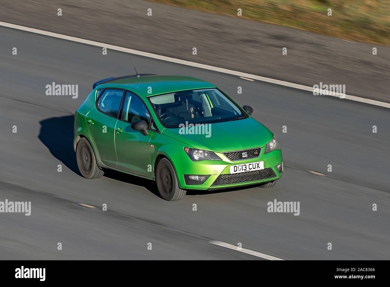 Blurred moving car 2013 SEAT Ibiza Fr Ts traveling at speed on the M61 motorway Slow camera shutter speed vehicle movement Stock Photo