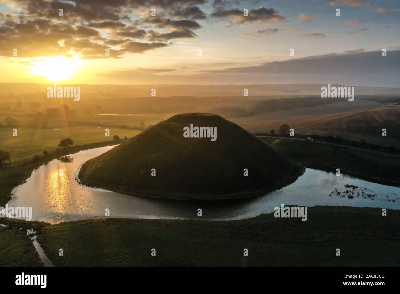 Silbury Hill, Nr Avebury, Wiltshire, UK. 30th November 2019. Sunrise drone images of the ancient man-made mound of Silbury Hill in Wiltshire almost co Stock Photo