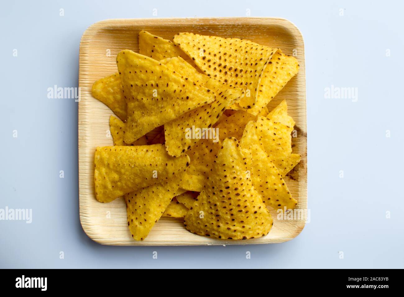 Tortilla chips placed on a palm leaf plate Stock Photo