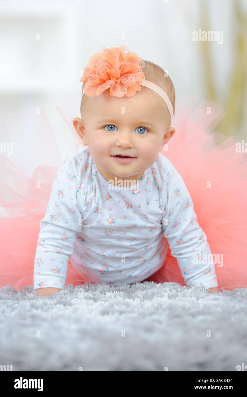 beautiful baby girl crawling and rolling over in bed Stock Photo Alamy