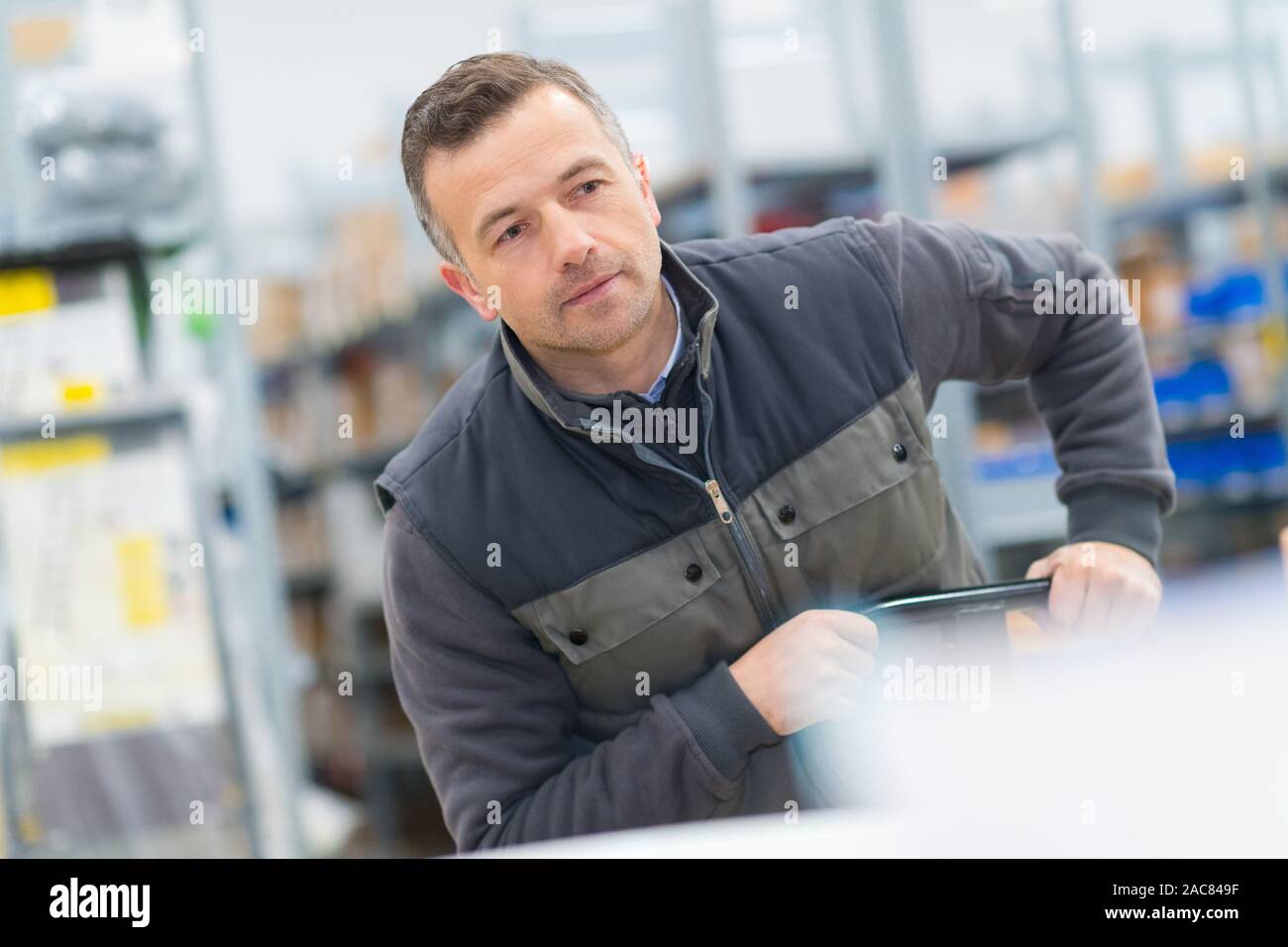 male worker using manual pallet truck Stock Photo