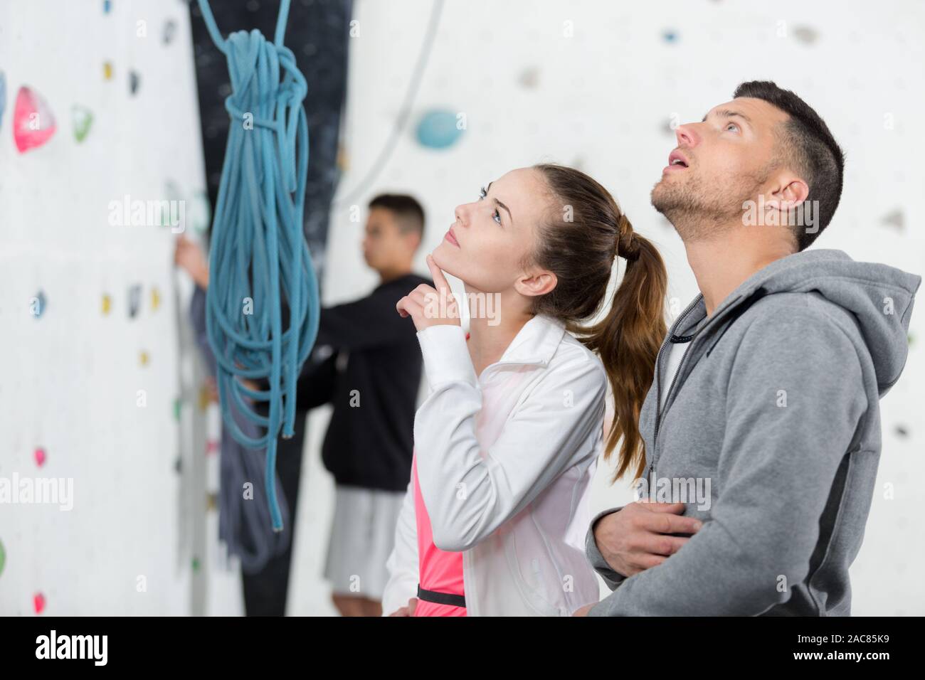climbers studying the artificial wall climbing routes Stock Photo Alamy