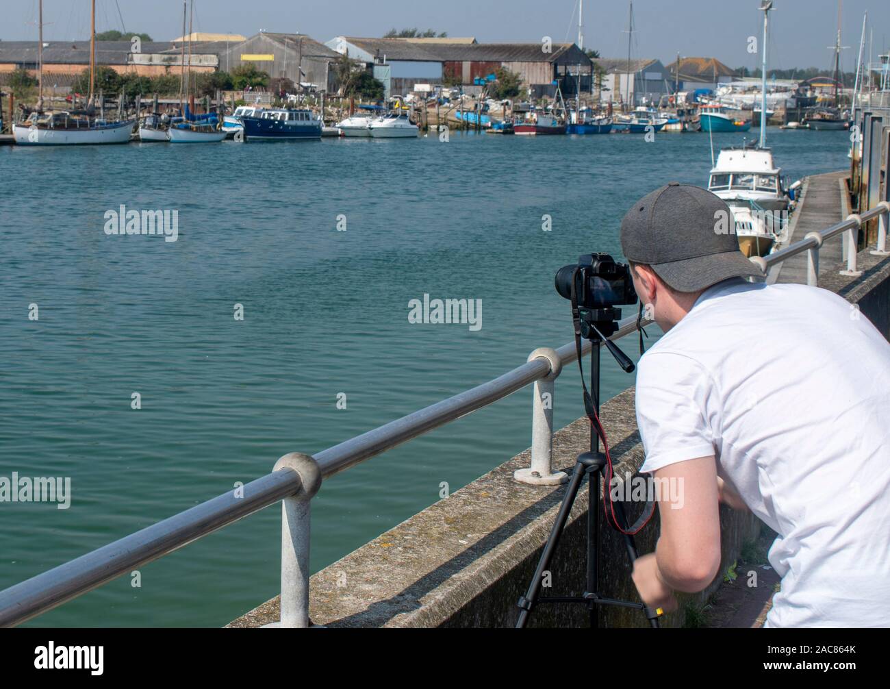 A photographer lining up an angle for a photo opportunity at a beautiful location by a river. Stock Photo