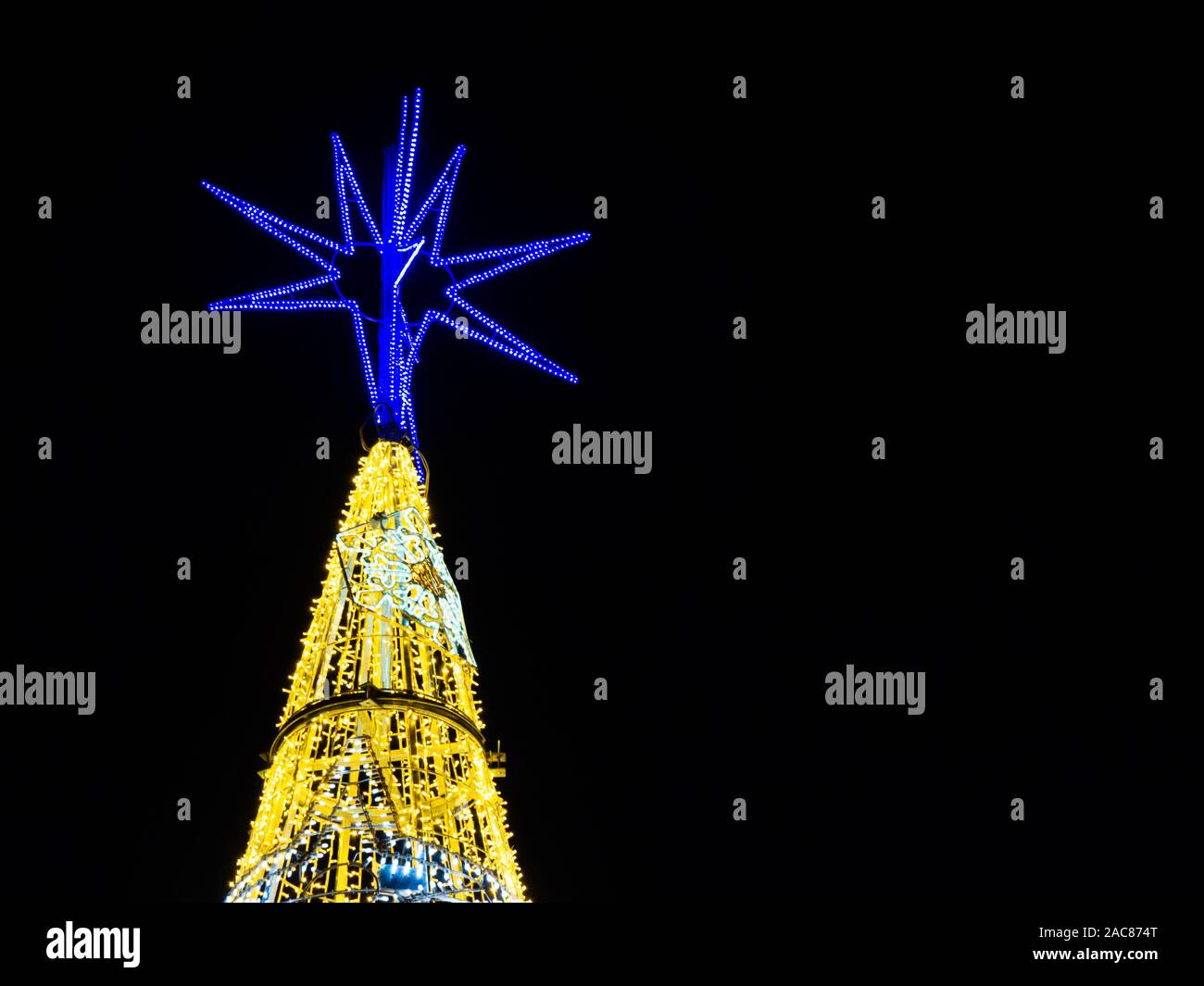 illuminated Christmas tree on black background with space for text Stock Photo