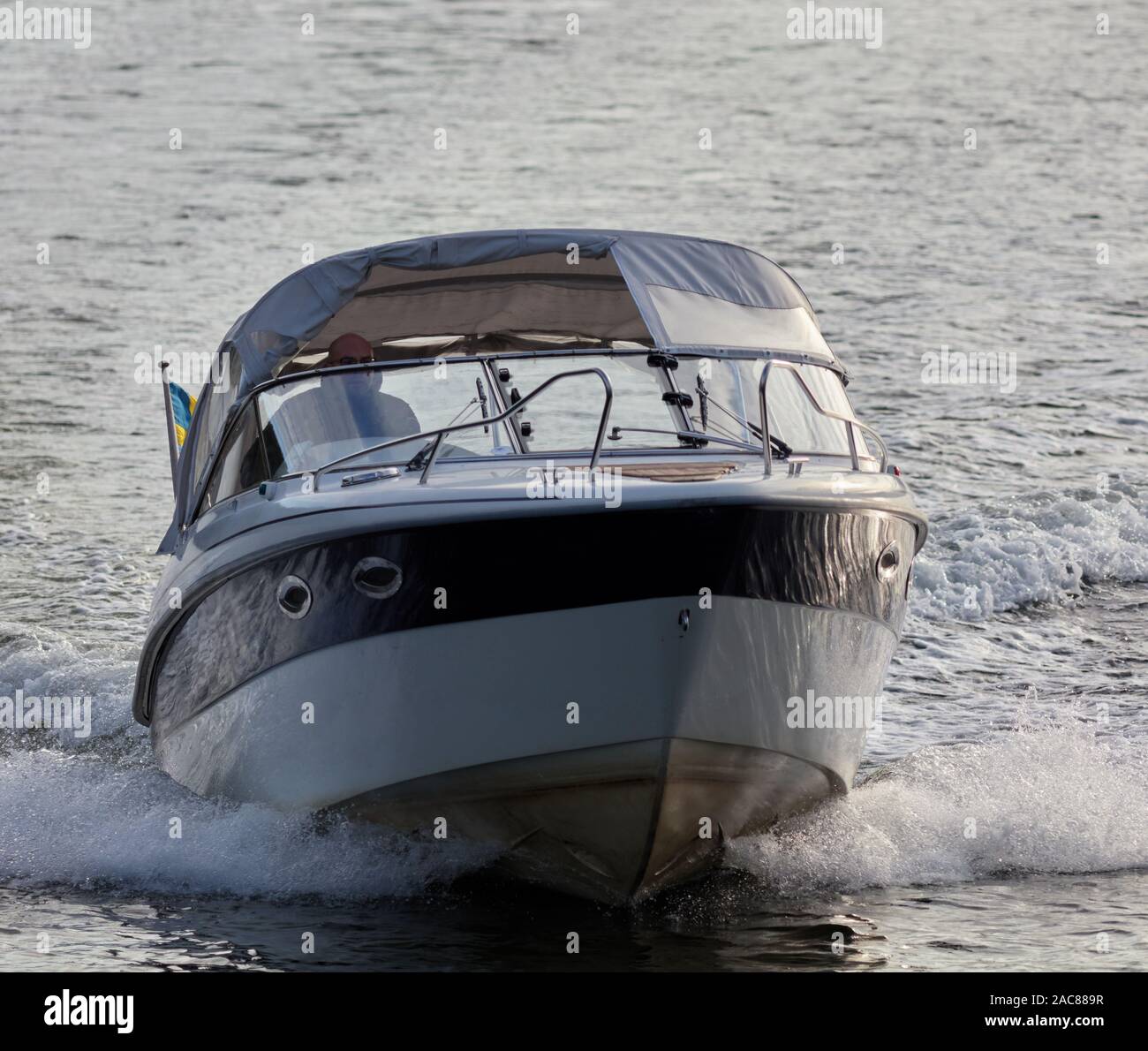 Man driving small boat hi-res stock photography and images - Alamy