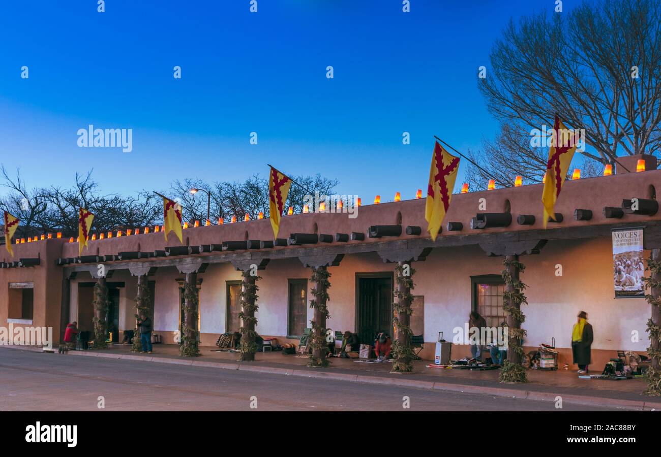 Santa Fe Christmas, Palace of the Governors on the plaza with farolitos at dusk, Santa Fe New Mexico, USA. Stock Photo