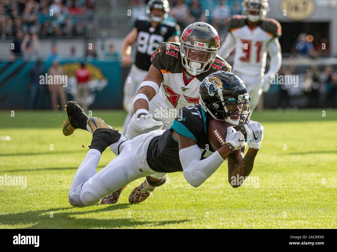 Jacksonville, FL, USA. 1st Dec, 2019. Tampa Bay Buccaneers cornerback Carlton Davis (33) is unable to defend a catch by Jacksonville Jaguars wide receiver D.J. Chark (17) during 2nd half NFL football game between the Tampa Bay Buccaneers and the Jacksonville Jaguars. Buccaneers defeated Jaguars 28-11 at TIAA Bank Field in Jacksonville, Fl. Romeo T Guzman/CSM/Alamy Live News Stock Photo