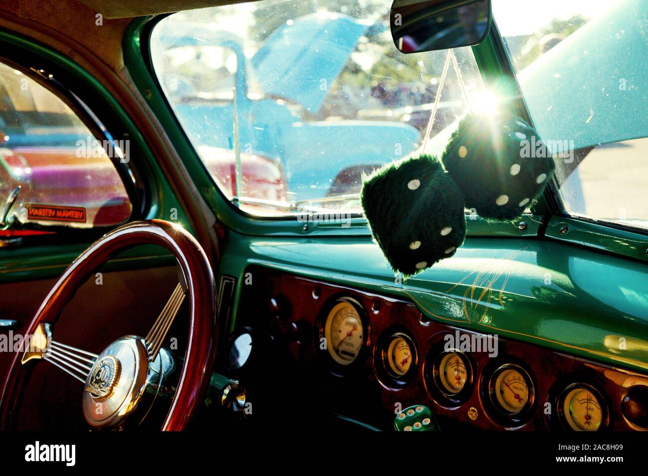 A vintage green car and interior with big fuzzy dice Stock Photo