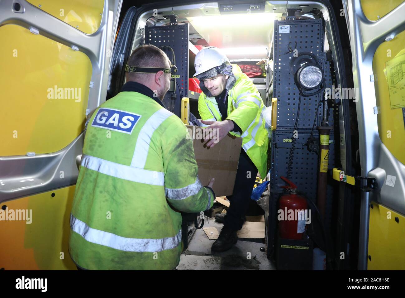 Gas engineers taking heaters out to vulnerable people, part of the distribution of heaters and hotplates at Camelon community centre, Falkirk, after a gas mains failure in central Scotland. Eight thousand properties are affected, with Gas infrastructure company SGN saying it will have to go door-to-door to turn off supplies in affected properties for safety reasons. Stock Photo