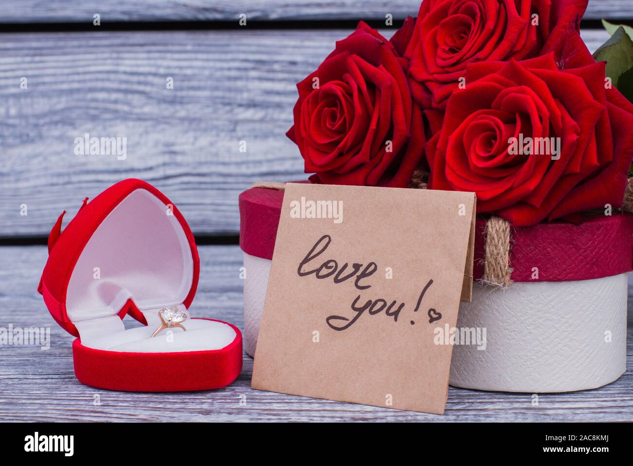 Golden ring, roses and love message Stock Photo - Alamy