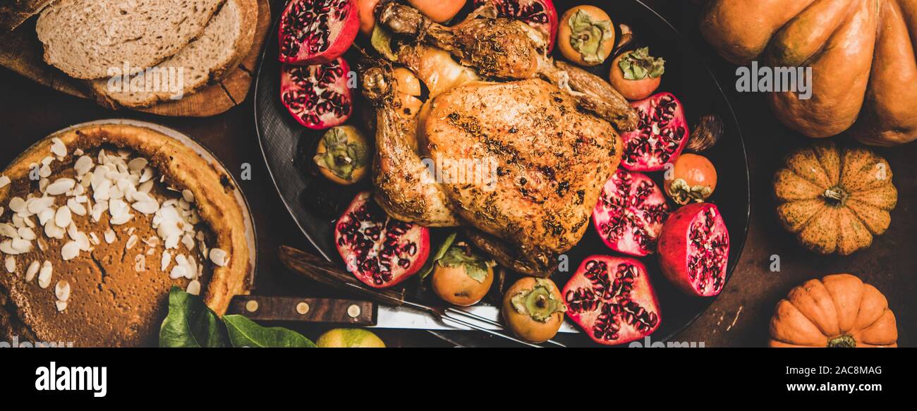 Thanksgiving table with roasted turkey and pumpkin pie, top view Stock Photo