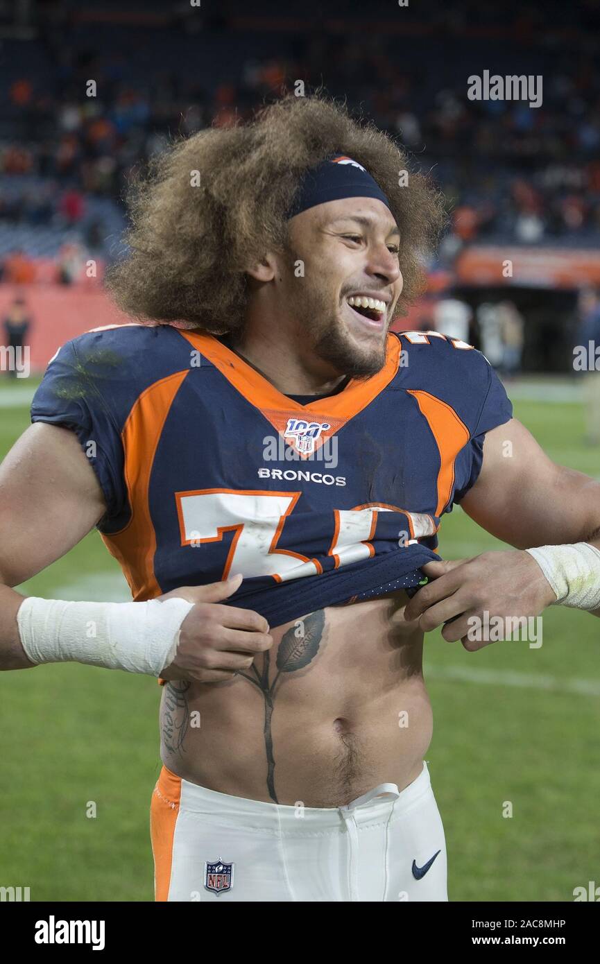 Denver, Colorado, USA. 1st Dec, 2019. Broncos RB PHILLIP LINDSAY starts to  take off his jersey to exchange with a Chargers player during the end of  the game at Empower Field At