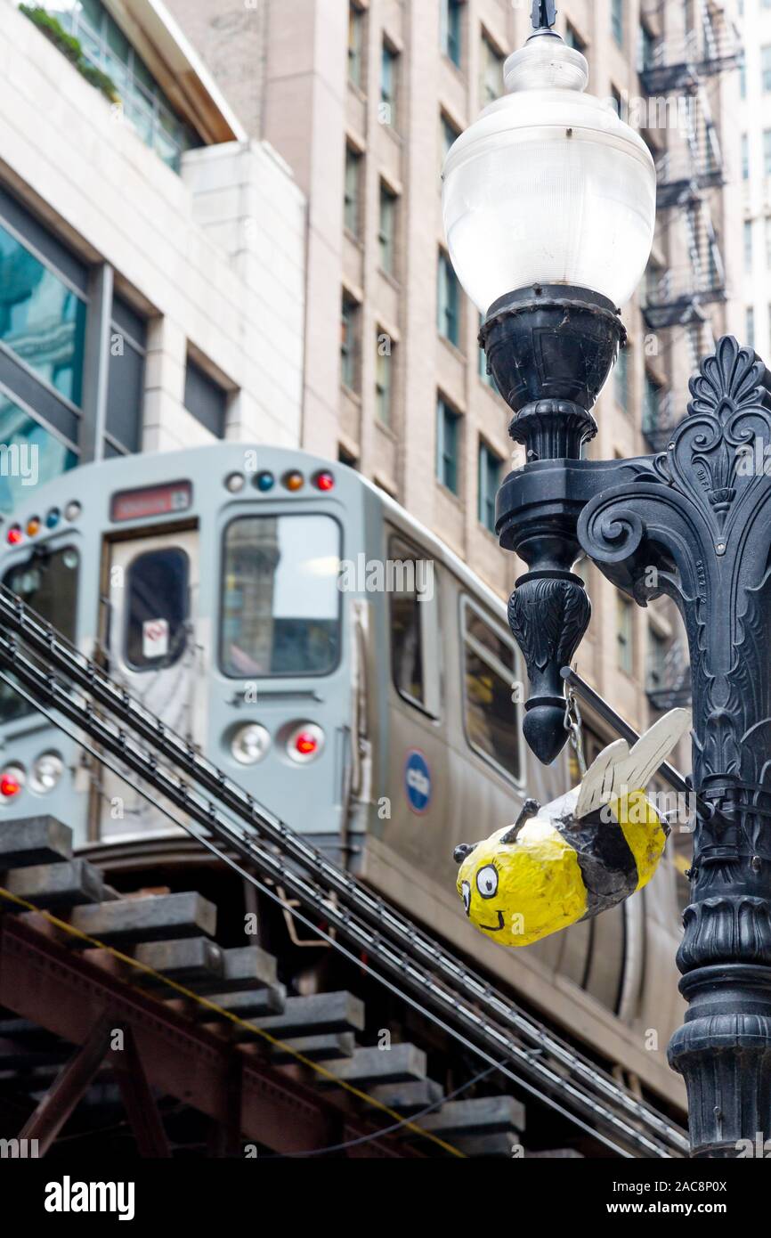 Paper Mache model hanging from streetlamp and L Train, Chicago, Illinois, USA Stock Photo