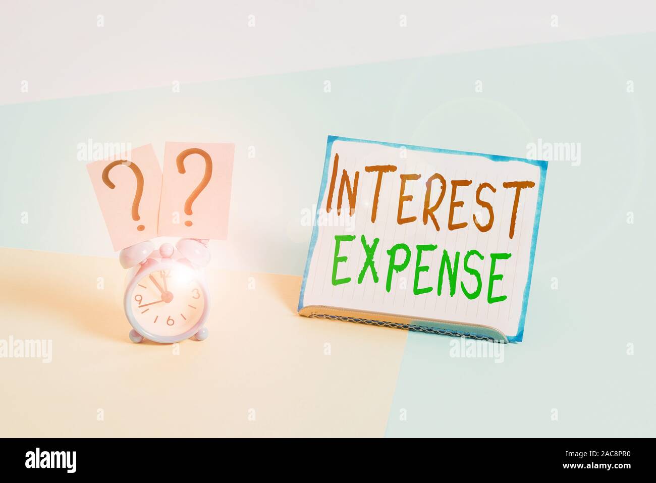 Conceptual Hand Writing Showing Interest Expense Concept Meaning Cost Of Debt That Has Occurred During A Period Of Time Alarm Clock Beside A Paper Sh Stock Photo Alamy