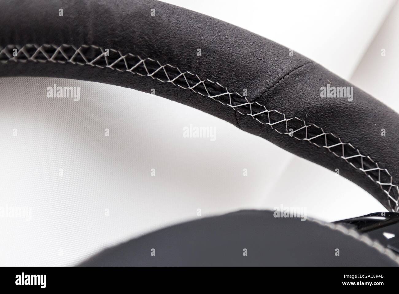 Leather steering wheel black color in the process of stitching with a