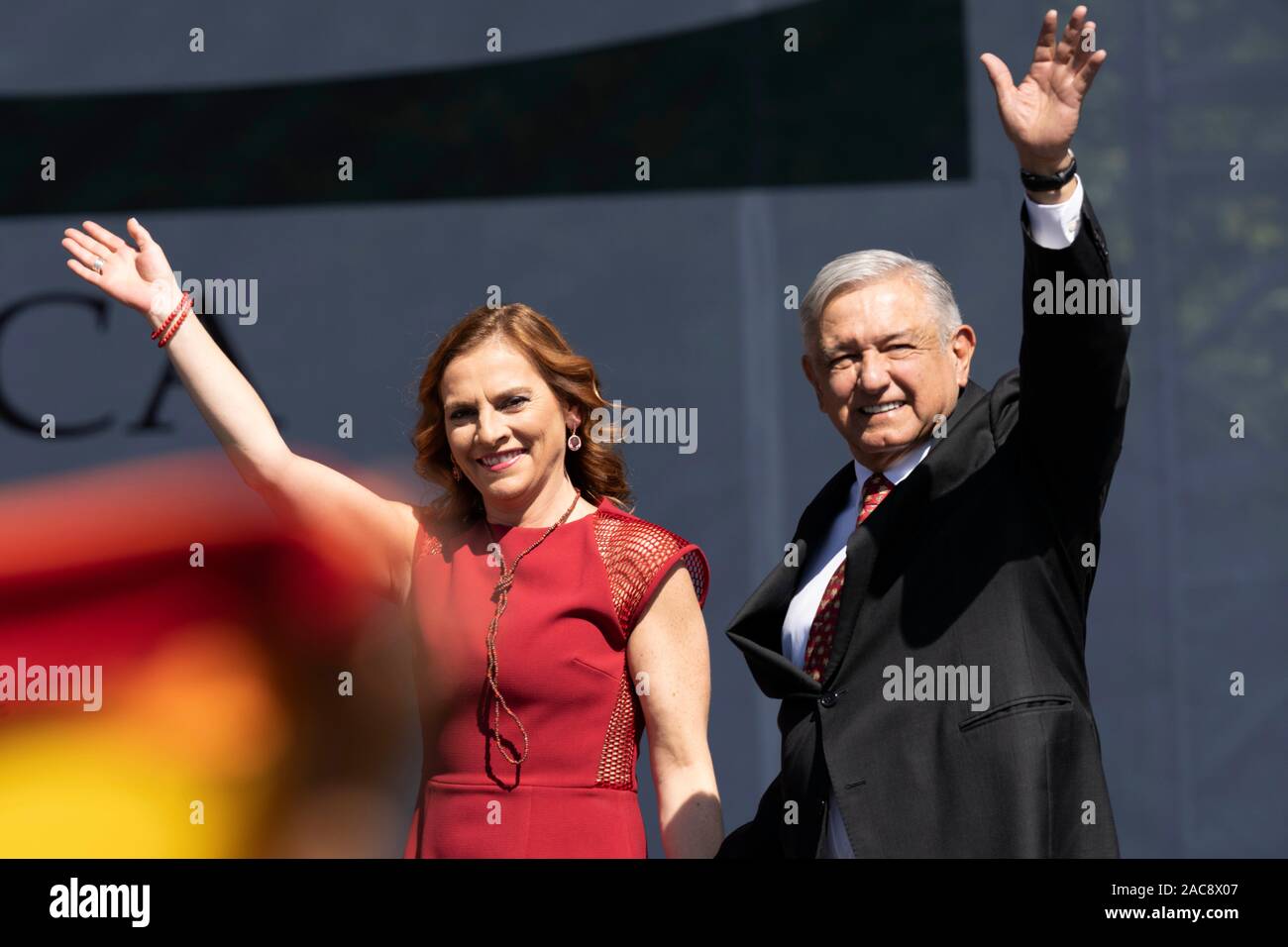 Mexico City, Mexico. 1st Dec, 2019. Mexican President Andres Manuel Lopez Obrador (R) greets his supporters accompanied by his wife Beatriz Gutierrez Muller during a ceremony marking his first full year in office in Mexico City, capital of Mexico, on Dec. 1, 2019. Decreasing Mexico's high rates of violent crime is the government's main challenge, President Andres Manuel Lopez Obrador said on Sunday. Credit: David de la Paz/Xinhua/Alamy Live News Stock Photo