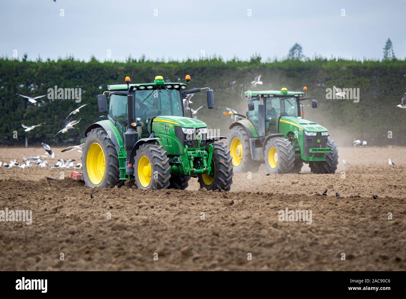 Sheffield, Canterbury, New Zealand, November 30 2019: John Deere tractors at work in a field cultivating the soil ready for potatoes to be planted Stock Photo