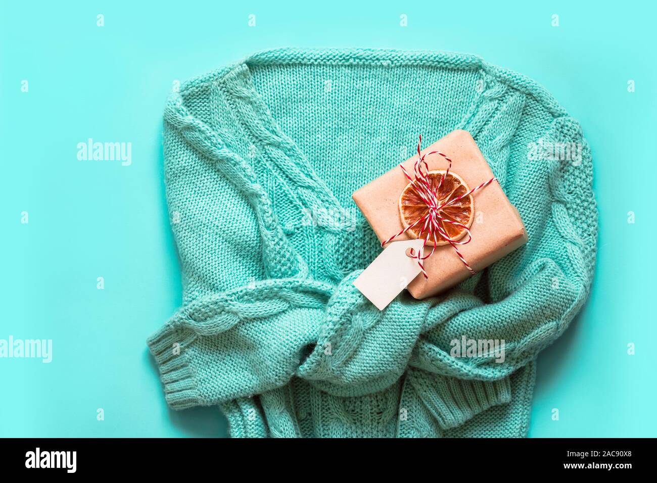 Mint Green pullover with with christmas gift zero waste decorated. Holiday concept. Stock Photo