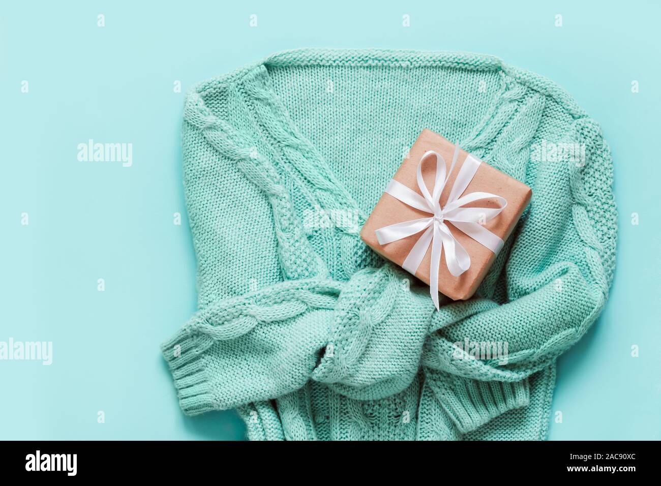 Mint Green pullover with gift box zero waste decorated. Holiday concept. Stock Photo