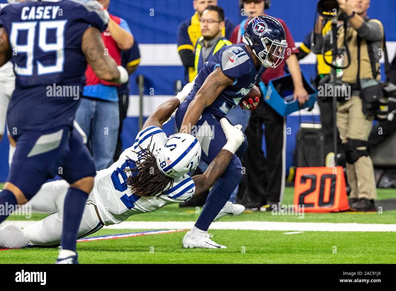 Indianapolis, Indiana, USA. 1st Dec, 2019. Tennessee Titans free safety Kevin Byard (31) is tackled by Indianapolis Colts tight end Mo Alie-Cox (81) after an interception in the second half of the game between the Tennessee Titans and the Indianapolis Colts at Lucas Oil Stadium, Indianapolis, Indiana. Credit: Scott Stuart/ZUMA Wire/Alamy Live News Stock Photo