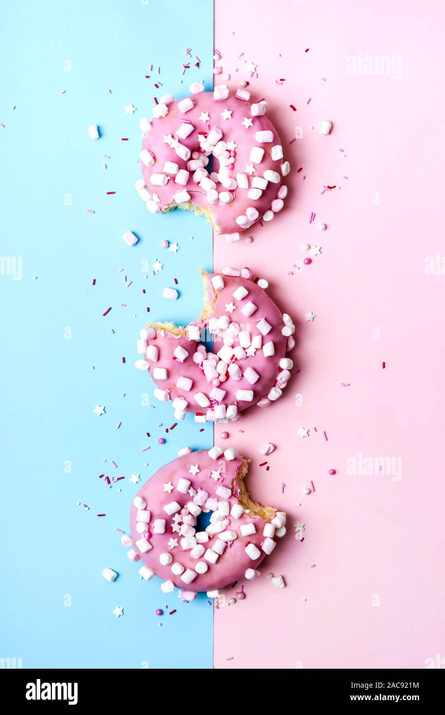 Creative layout made of pink bitten donuts. Food concept. Stock Photo