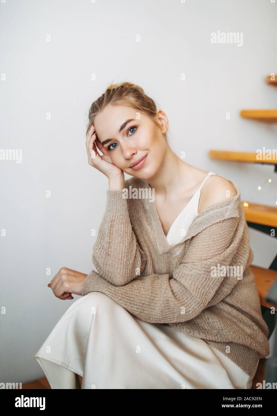 Young Beautiful Girl With Blonde Hair In Evening Beige Silk Dress