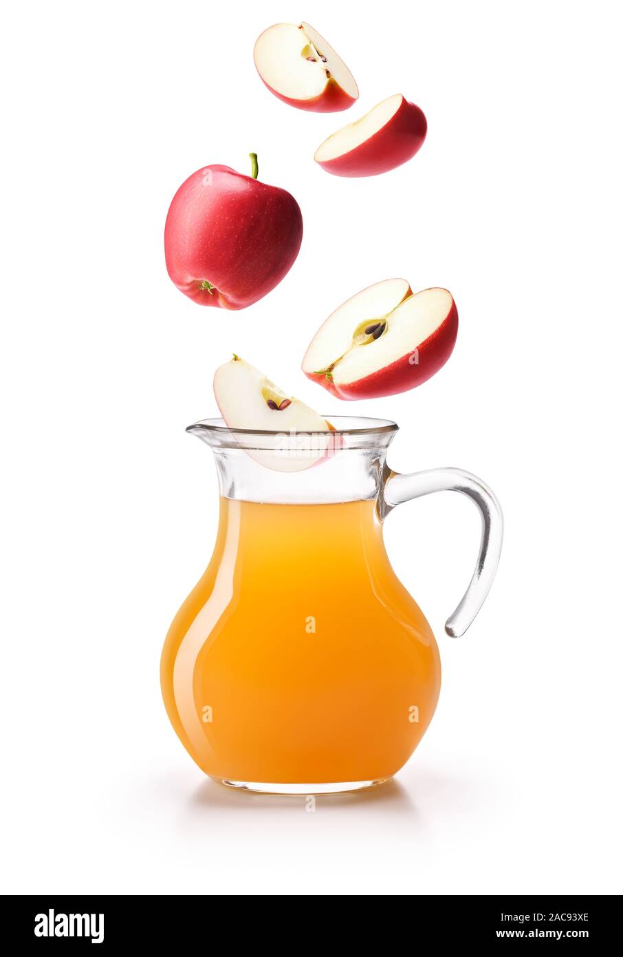 Apples dropping on a jug of apple cider vinegar, isolated on white background Stock Photo Alamy