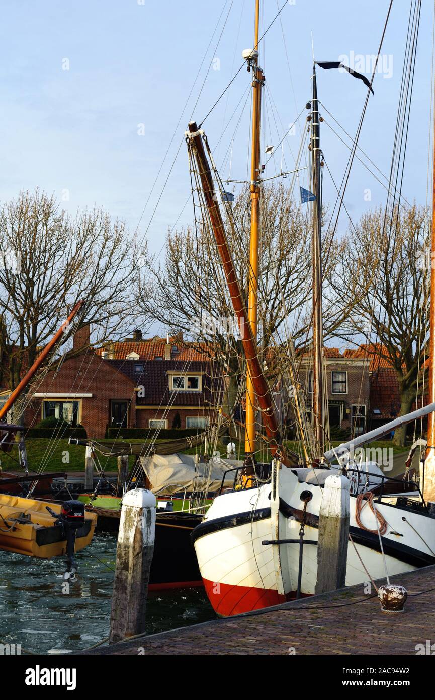 Enkhuizen, North Holland / Netherlands - March 05, 2012: Yachs near the pier in little city harbor of Enkhuizen, Netherlands. Stock Photo