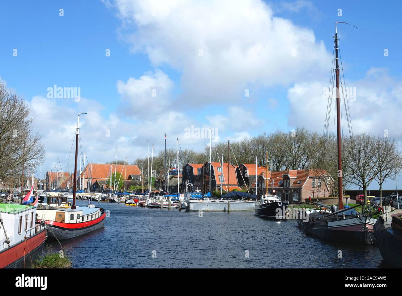 Enkhuizen, North Holland / Netherlands - April 14, 2014: Yachs near the pier in little city harbor of Enkhuizen, Netherlands. Stock Photo