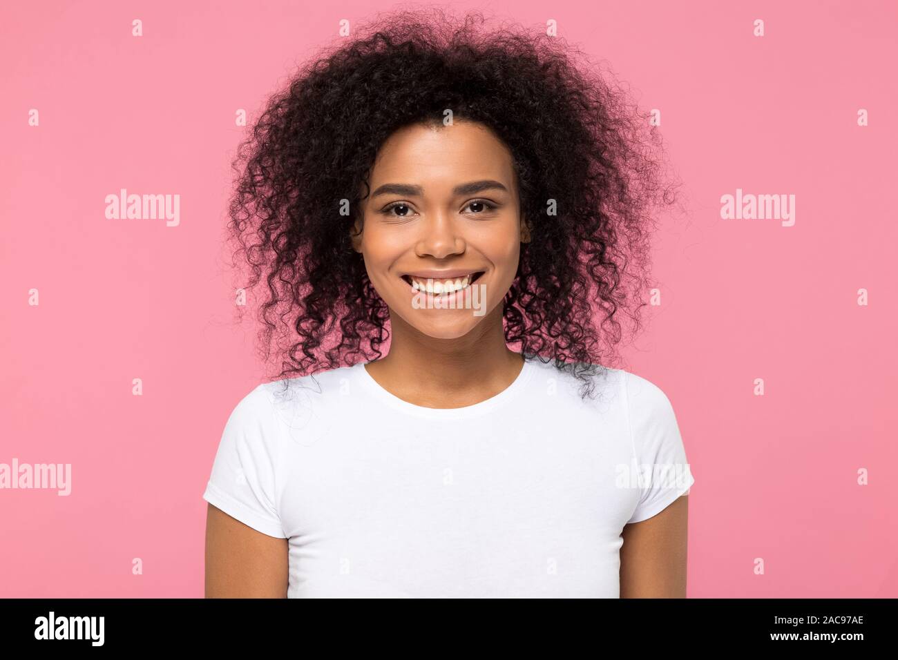 Head shot portrait smiling African American woman looking at camera ...