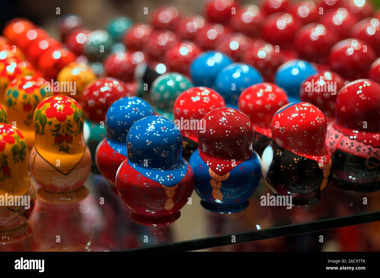 Colorful vintage nesting dolls with their backs turned stand in rows