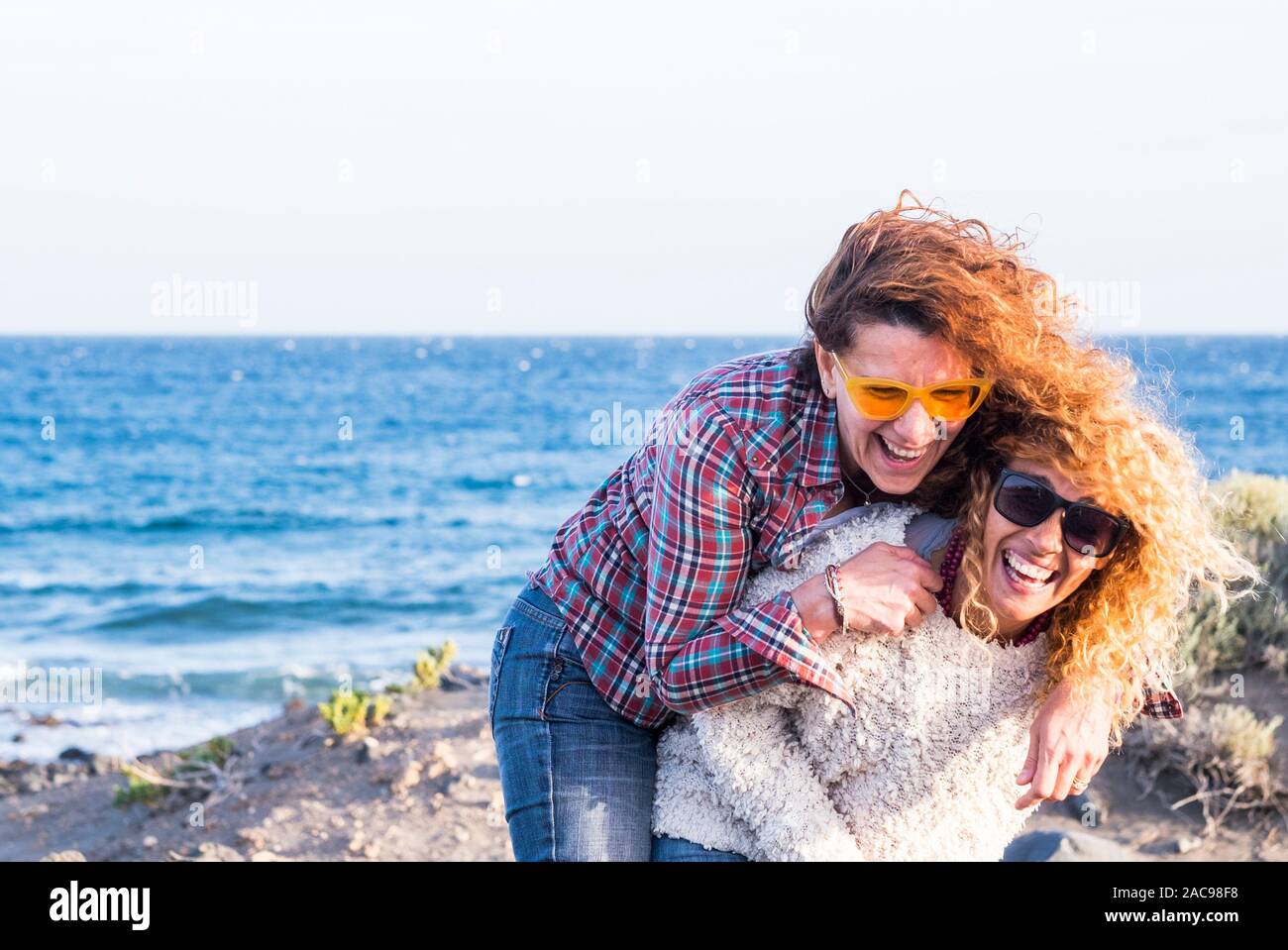 Couple Of Adult Nice Caucasian Women Play Together Carrying Eachother