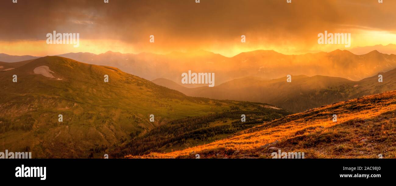 A stunningly brilliant golden hour display during a thunderstorm from the Gore Range Overlook on Trail Ridge Road, Rocky Mountain National Park, Color Stock Photo