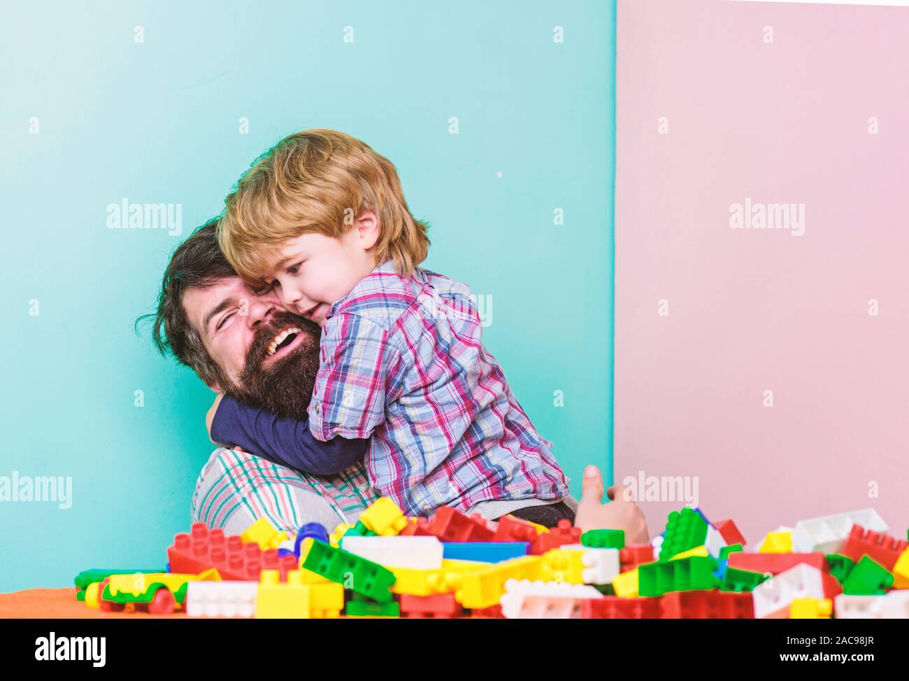 My family. father and son play game. small boy with dad playing together. happy family leisure. child development. building home with colorful constru Stock Photo