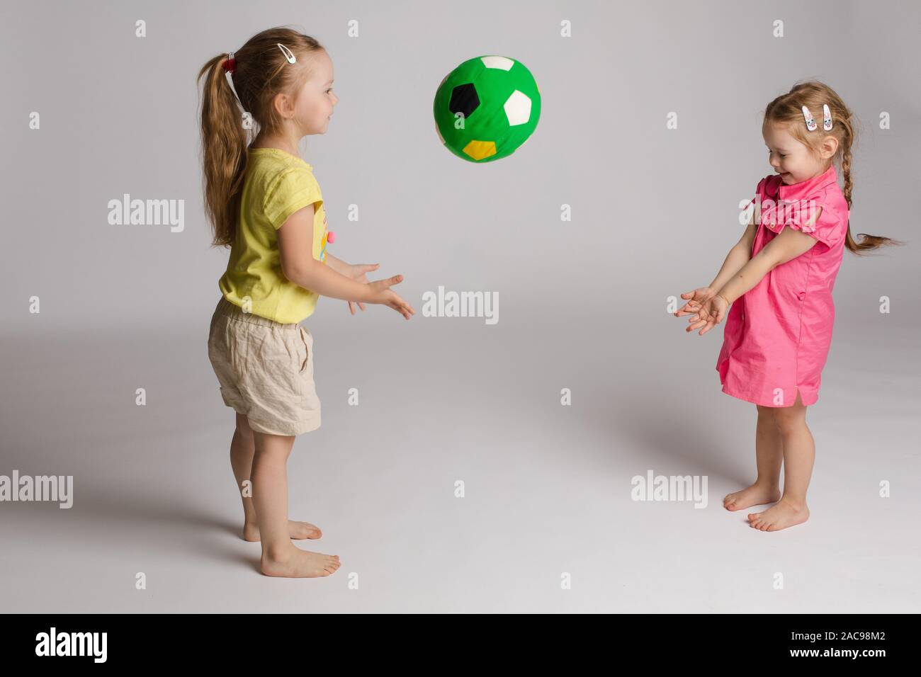 Ccheerful kids throwing and catching ball. Concept of happiness and