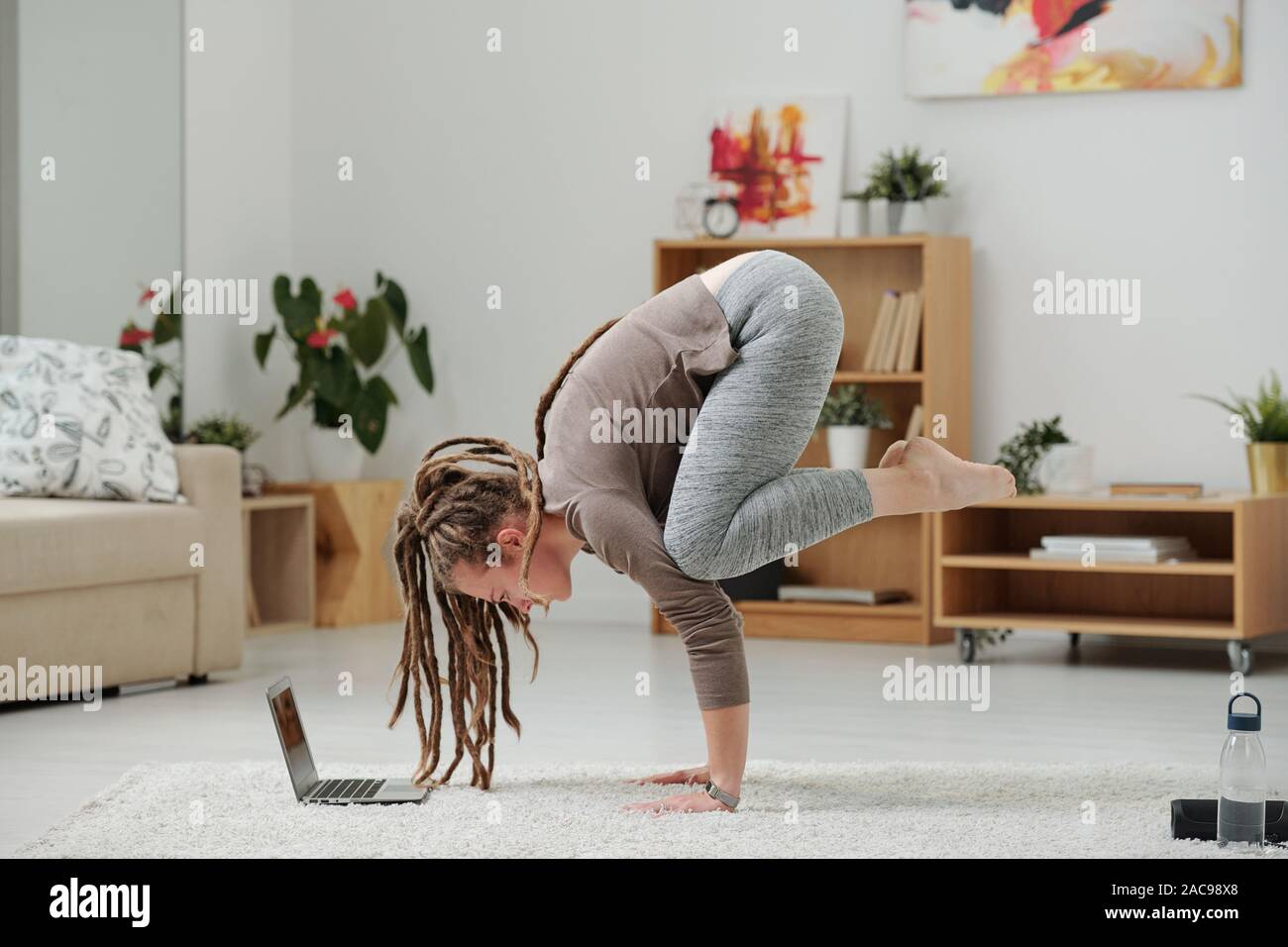 Pretty Girl With Dreadlocks Standing On Hands In Front Of