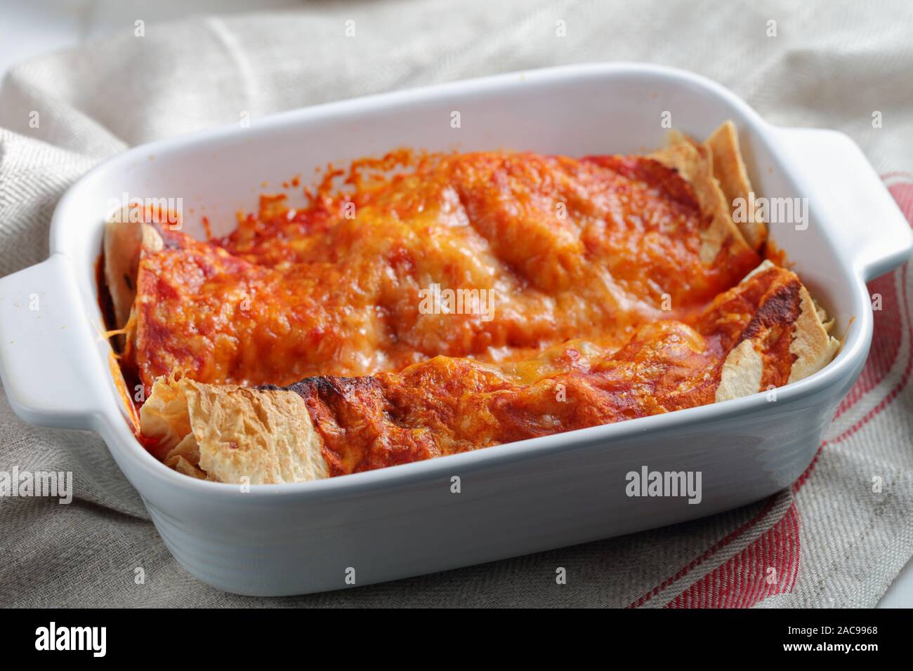 Two enchiladas in a baking dish closeup Stock Photo