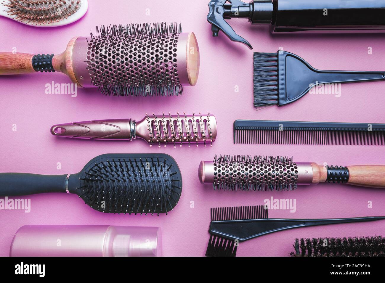 Various Hair Dresser And Cut Tools On Pink Background With Copy