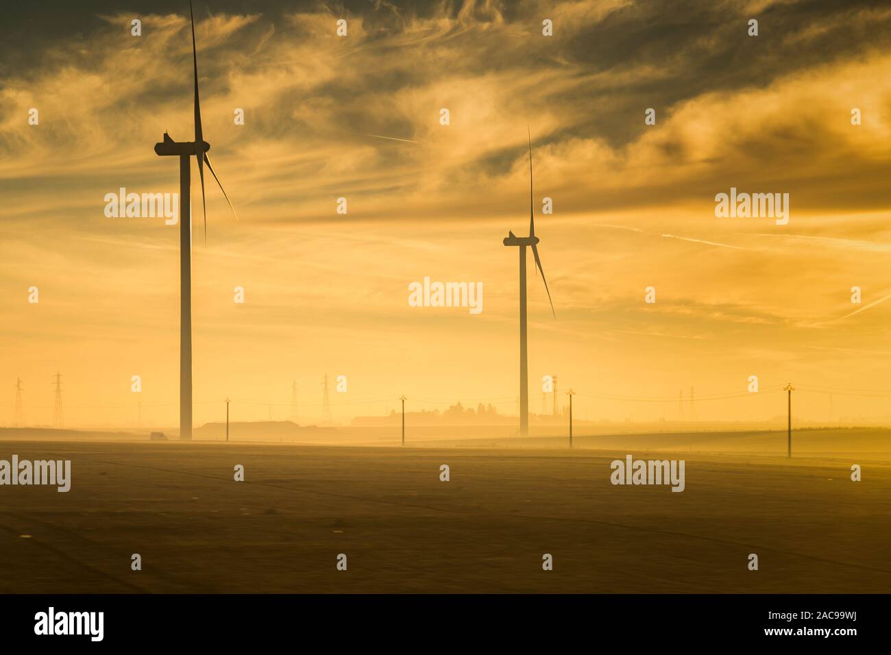 Silhouette of a windmill captured at sunrise , France Stock Photo