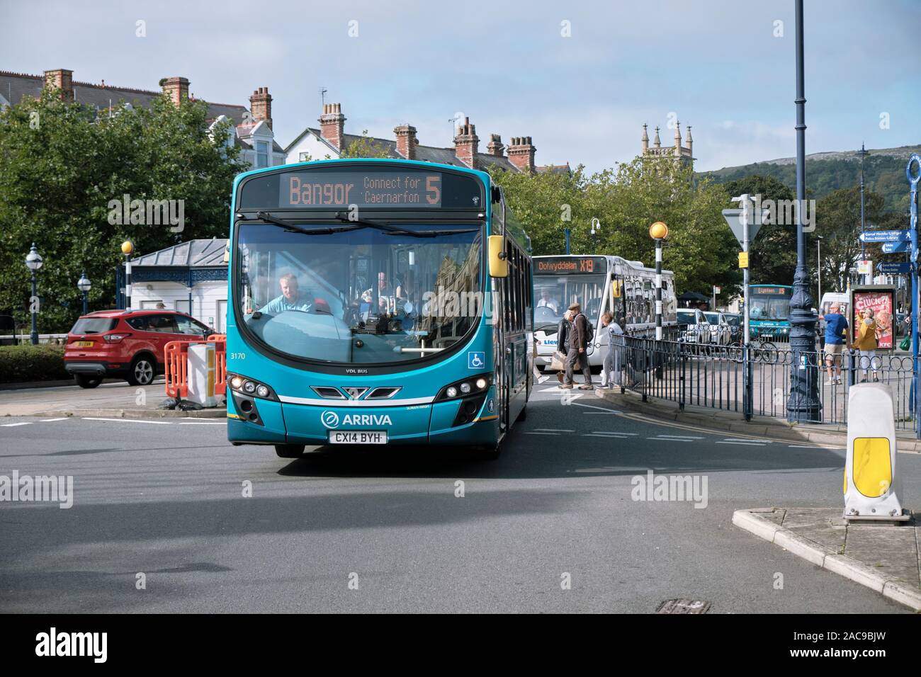 Intercity Arriva wales bus heading to Bangor, in roundabout in centre of Llandudno, Wales. Stock Photo