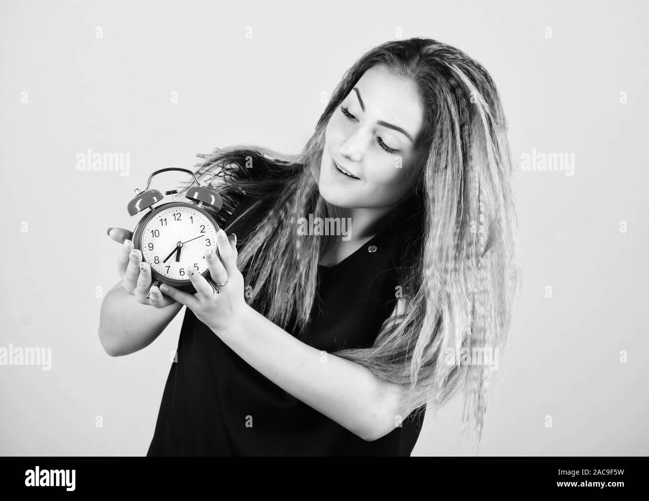 Woman hold vintage alarm clock. Practice of advancing clocks. Daylight