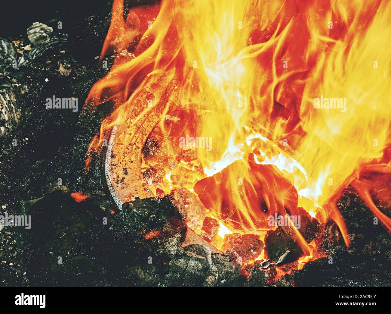 Burning fire in the blacksmith coal Red hot tongs to