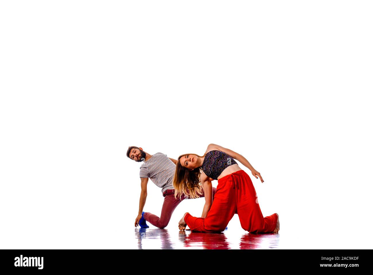Teenagers skill and talent of modern dance, dancing in studio over white background Stock Photo